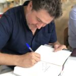 Óscar Mijallo firmando libros